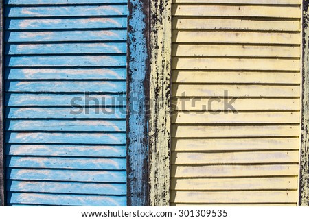 rustic window closed with contrast color wooden exterior shutters