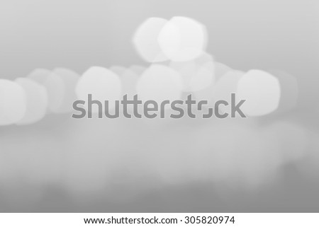 Beautiful black and white blurred lights on a light gray background