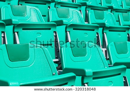 green plastic stadium seats in rows. The seats are filled the frame as background. , Empty Plastic Chairs at the Stadium