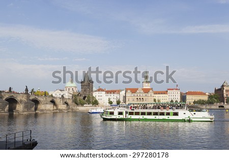 PRAGUE, CZECH REPUBLIC - MAY 14, 2011: River cruise boats transport tourists along the Vltava River near the Charles Bridge in Prague.  The historical centre of Prague is a UNESCO World Heritage Site.
