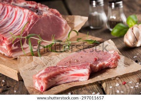 Raw pork chop on wooden table