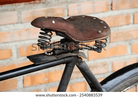 Similar – Image, Stock Photo Old bicycle saddle with visible springs and rust