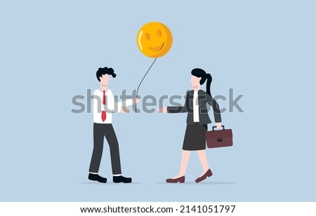 Sharing positive energy between workmates, making positive vibe in workplace, or giving happiness to release stress from work concept. Businessman giving happy face balloon to coworker.