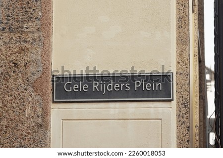Blue street name sign of Gele Rijders Plein on a beige stone wall  in Arnhem in the Netherlands Stockfoto © 
