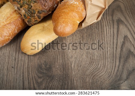 baguettes bread  in paper bag on wooden background