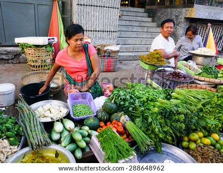 Yangon, Myanmar - Jan 14, 2015. Burmese women selling fresh fruits and vegetables at Bogyoke market in Yangon, Myanmar.