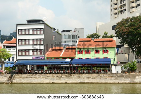 SINGAPORE - JUL 18, 2015. Colorful bars and restaurants dot the Singapore River along Clarke Quay. The area used to be a commercial center during the colonial era.