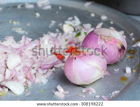 Onion prepared on cutting board to be cooked at the food market in Gaya, India.