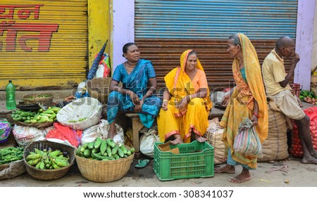 Bodhgaya, India - Jul 13, 2015. Indian women selling vegetables in a crowded market in Bodhgaya, India. Its a common practice in India to sell vegetables in open markets and streets.