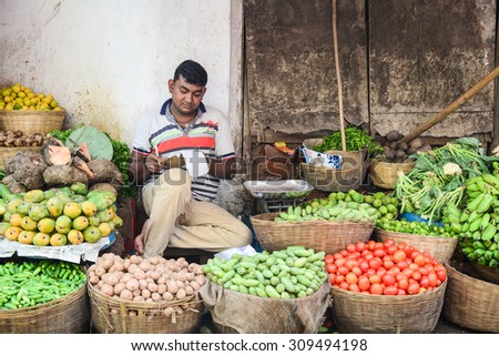 DELHI, INDIA - AUG 5, 2015. Unidentified men sell fruits from a stall in Delhi, India. Street vendors are widly spread through out the city.