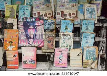 KOLKATA, INDIA - JUL 8, 2015. Street seller sell second hand books on various subjects in Kolkata, India. Common scene through out the year in busy streets.