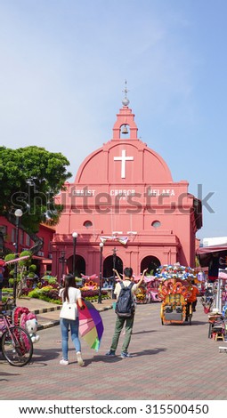 MALACCA, MALAYSIA - AUG 7, 2015. Day view of Christ Church & Dutch Square in Malacca City, Malaysia. It was built in 1753 by Dutch & is the oldest 18th century Protestant church in Malaysia.