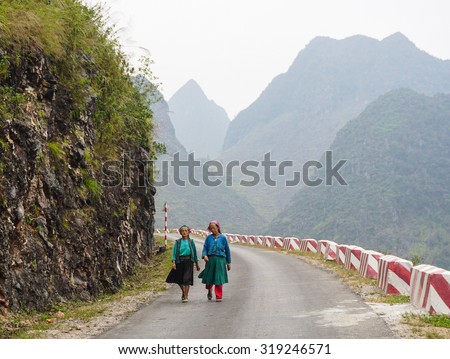 HA GIANG, VIETNAM - SEP 2, 2015. People walking on countryside road to coming home after finish work in Ha Giang, north of Viet Nam.