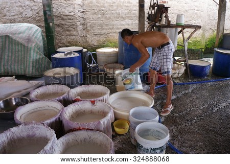 CAN THO, VIETNAM - NOV 10, 2014. An unidentified man making rice noodles in Mekong delta, Can Tho, Vietnam.