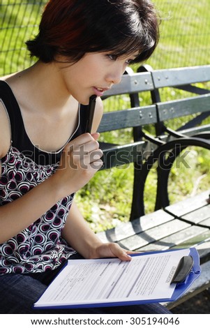 Young woman thinking about a job application.