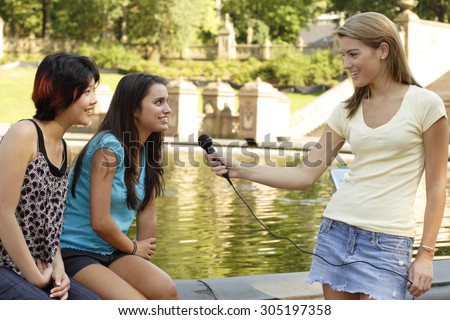 Woman interviewing two other women.