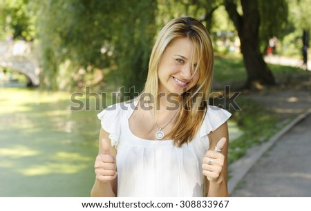 Young woman with thumbs up.