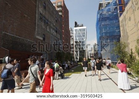 New York, New York, USA - June 20, 2011: People strolling along The High Line. The High Line is an NYC park located on what used to be an elevated rail line.