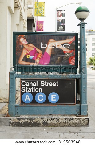 New York, New York, USA - June 20, 2011: A Canal Street subway station entrance with a Bebe poster on Canal Street in lower Manhattan. Tribeca Film Festival signs can be seen in the background.
