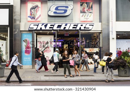 New York, New York, USA - September 23, 2015: People walking by a Skechers store on 34th street in Manttan. Skechers is a manufacture and retailer of footwear.