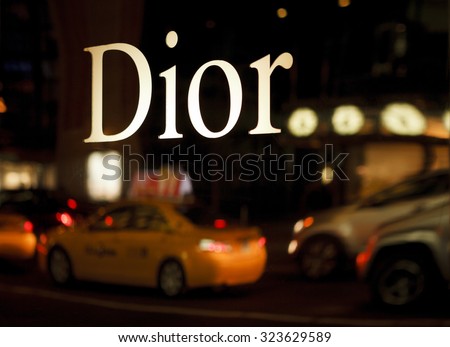 New York, New York, USA - October 22, 2011: The reflective Dior sign on the Christian Dior boutique on 57th street In Manhattan. The reflection of nighttime street traffic can be seen below the logo.
