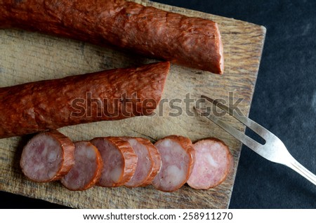 Tasty sausage on a wooden board