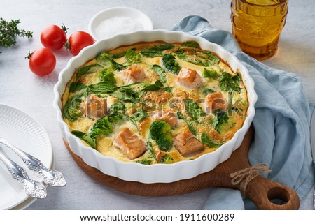 Egg-based frittata, omelette with salmon, broccoli and spinach. Italian dish, crustless quiche with eggs, fish and vegetables. Mediterranean ketogenic healthy diet Foto d'archivio © 