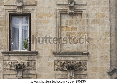 French Window with Blank Wall. A french window with delicate net curtains sits beside a walled up window space. Found in Bordeaux, France.