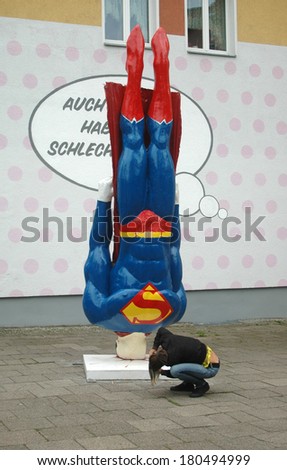 CIRCA AUGUST 2006 - BERLIN: art installation: a crashed Superman comic figure, Kastanienallee, Berlin-Prenzlazuer Berg.