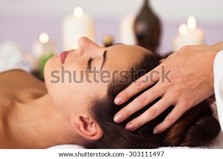 Pretty woman relaxing in the beauty treatment. Facial massage. Spa, resort, beauty and health concept
