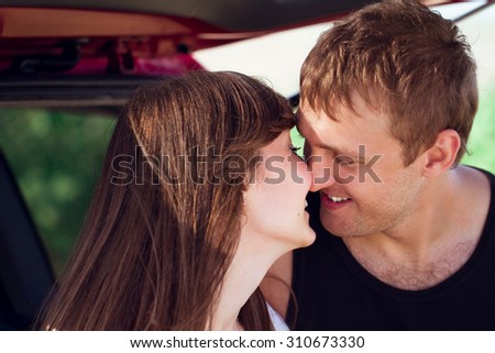 young smile couple romantic kissing sitting in car , summer season