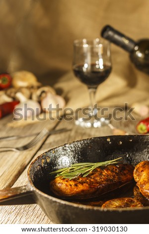 Thanksgiving Day.  Wine. Protein. Meat on frying pan. Vegetables and wine in a grocery, a bottle of wine. Blurring background. Wooden table.