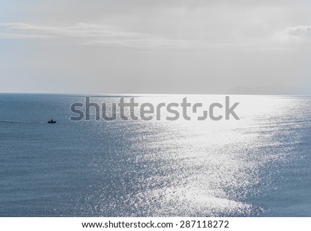 Boat sailing in the gazing sun on the Mediterranean Sea.