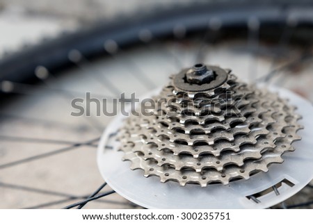 Bike wheel gear cassette, on wheel lying on the ground.