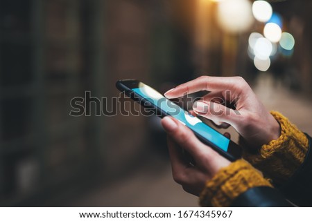 point finger on screen mobile phone closeup, person texting text message, hipster touch blue screen on smartphone light night city, girls using in hands cellphone close up, online internet