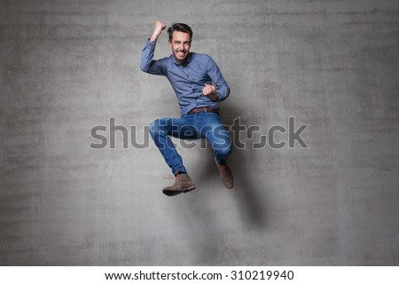 euphoric business man jump wall