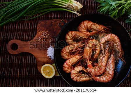 fried until golden brown tiger shrimp are ready in a pan and serving at the table