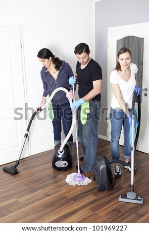 Three persons cleaning a house
