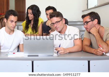 Students studying with laptops in class room