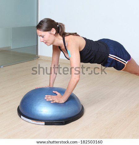 Fitness woman on a stability disk