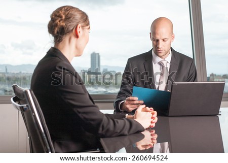 Boss evaluates a female worker