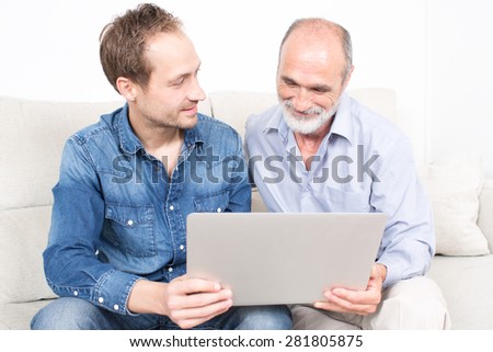 Father and older son looking at laptop
