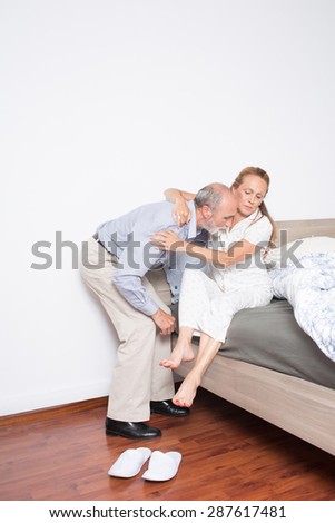 Man nursing elderly woman