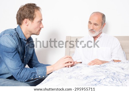 Elderly son takes care of ill father