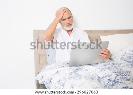Elderly man looking for a doctor on the internet