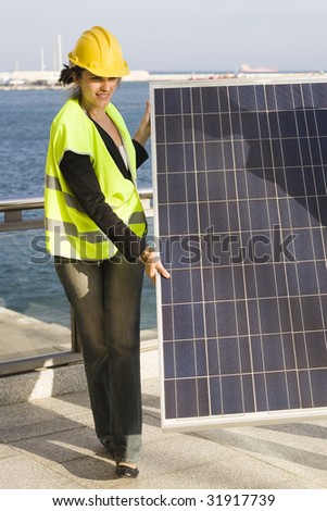 Young woman transporting a solar panel