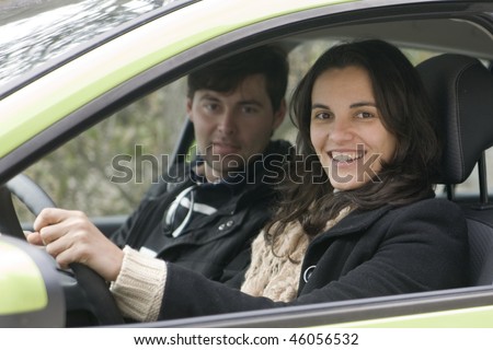 Woman and man in car behind the wheel