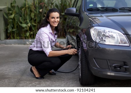 Woman fills tire in car