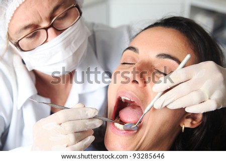 Hispanic woman at the dentist with the mouth wide open