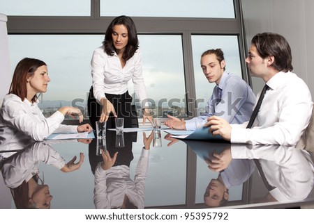 latin businesswoman in an office with her team in an office